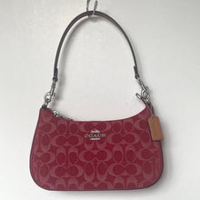 Load image into Gallery viewer, Red handbag with a visible brand tag on a white background