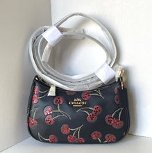 Load image into Gallery viewer, Coach handbag with cherry design on a white background