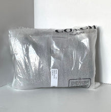 Load image into Gallery viewer, Gray sweatshirt in clear packaging with Coach branding on a white background