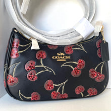 Load image into Gallery viewer, Coach handbag with cherry pattern on a white background