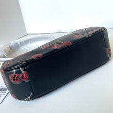Load image into Gallery viewer, Black clutch bag with cherry pattern on a white surface