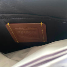 Load image into Gallery viewer, Close-up of a brown leather patch on a dark fabric surface