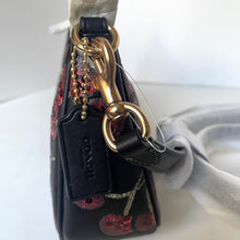 Load image into Gallery viewer, Coach handbag with floral pattern and gold hardware on a white background