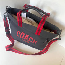 Load image into Gallery viewer, Coach bag with red straps on a light background