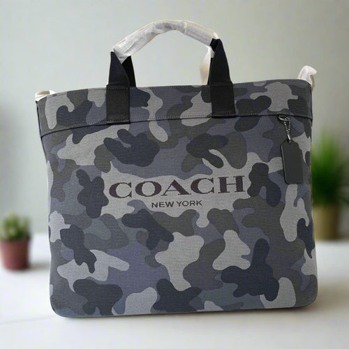 Camouflage-patterned bag with 'Coach New York' logo on a white background