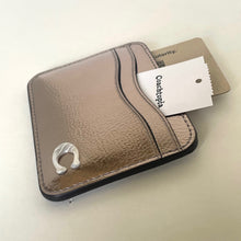 Load image into Gallery viewer, Brown leather cardholder with a tag on a light beige background
