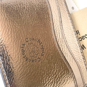 Close-up of Coachtopia logo on a textured surface