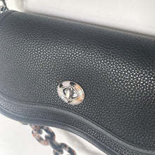 Load image into Gallery viewer, Close-up of a black textured handbag with a silver clasp on a white background