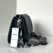Load image into Gallery viewer, Black handbag with a chain detail and a visible tag on a white background