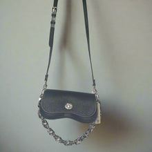 Load image into Gallery viewer, Black leather handbag with a chain detail on a light gray background