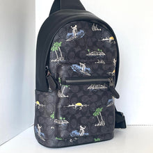 Load image into Gallery viewer, Black backpack with tropical pattern on a white background