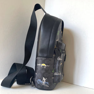 Black backpack with nature-themed design on a white background