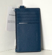 Load image into Gallery viewer, Blue wallet with Coach tag on a white background