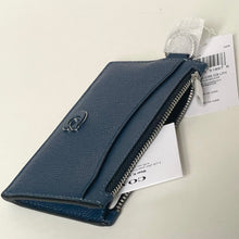 Load image into Gallery viewer, Blue wallet with a brand tag on a light gray background