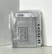Load image into Gallery viewer, Silver glittery pouch with Coach branding on a white background