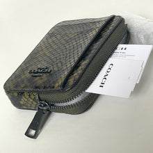 Load image into Gallery viewer, Coach pouch with a pattern and a visible brand tag on a white background