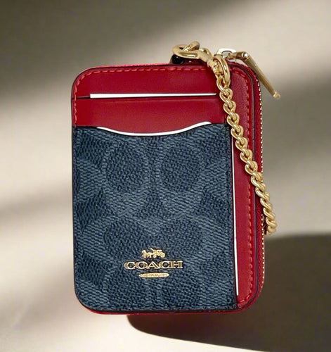 Red and blue Coach wallet with gold chain on a white background