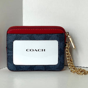 Coach wallet with red top section and gold chain on a white background