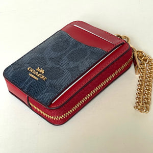 Red and blue Coach wallet with gold chain on a light background