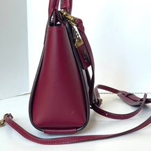 Load image into Gallery viewer, Maroon handbag with gold accents on a white background