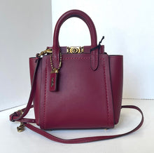 Load image into Gallery viewer, Maroon handbag with gold accents on a white background