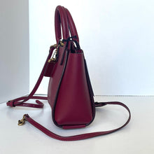 Load image into Gallery viewer, Maroon handbag with a strap on a white background
