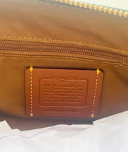Load image into Gallery viewer, Close-up of a brown nylon bag with a brown leather patch showing the embossed brand name REDGOLD.