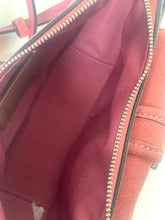 Load image into Gallery viewer, Close-up of the interior of a dusty rose or mauve-colored handbag, showing the lining, silver zipper, and interior stitching.
