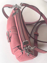 Load image into Gallery viewer, A dusty pink suede crossbody bag with silver-tone hardware, a front flap pocket with a silver buckle, and a long adjustable shoulder strap, shown on a plain light background.