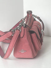 Load image into Gallery viewer, A Coach handbag in dusty pink textured leather with silver-tone hardware and a visible Coach logo on the front, photographed against a plain light background.