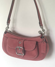 Load image into Gallery viewer, A dusty rose faux-leather shoulder bag with a front flap pocket featuring a silver-tone buckle, a top zipper, and a matching leather hangtag.