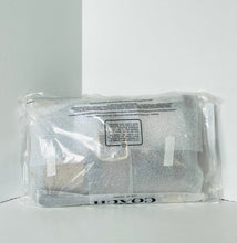Load image into Gallery viewer, A Coach handbag in clear plastic packaging, resting on a white surface against a white background.