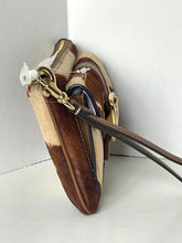 Load image into Gallery viewer, A close-up of a brown and beige patchwork handbag with gold-tone hardware and a dark brown strap, photographed against a plain light gray background.