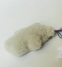 Load image into Gallery viewer, A small, fluffy off-white faux fur pouch or accessory with a metal clip, resting on a plain white surface with tags attached.