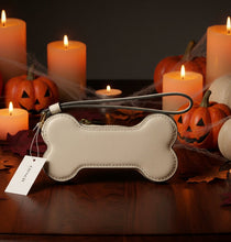 Load image into Gallery viewer, Dog bone-shaped pouch with a strap on a light gray background