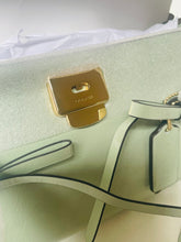 Load image into Gallery viewer, Light green handbag with gold clasp on a white background