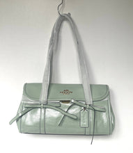 Load image into Gallery viewer, Light green handbag with a visible brand logo on a white background