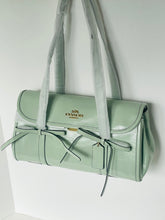 Load image into Gallery viewer, Green handbag with a visible brand logo on a white background