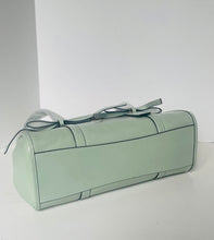 Load image into Gallery viewer, Light green cylindrical pouch with a strap on a white background