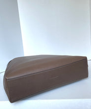 Load image into Gallery viewer, A brown leather rectangular storage bag or organizer, shown from a side angle on a white surface against a white background.