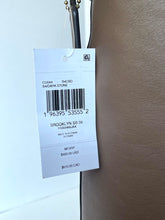 Load image into Gallery viewer, A white retail hangtag attached to a brown leather or faux-leather surface, showing product details including a barcode, SKU, and price information.