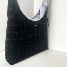 Load image into Gallery viewer, Black textured handbag with 'Coach' logo on a white background
