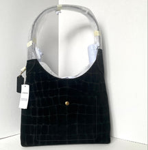 Load image into Gallery viewer, Black textured handbag with a tag on a white background