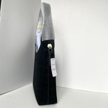 Load image into Gallery viewer, Black textured bag with a gray sweater inside, on a white background