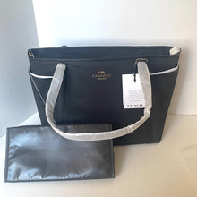 Load image into Gallery viewer, Coach black tote bag with gray handles on a light surface
