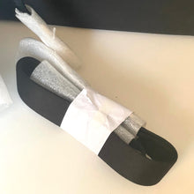 Load image into Gallery viewer, Black shoe insole with white and gray foam layers on a white background