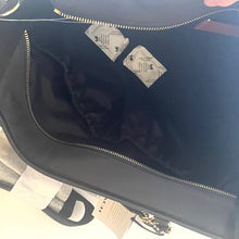 Load image into Gallery viewer, Close-up of a dark blue bag with a visible brand logo on a light background