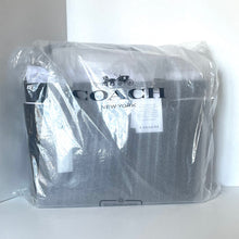Load image into Gallery viewer, Coach bag in clear plastic packaging on a white background