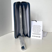 Load image into Gallery viewer, Blue zippered pouch with gray interior and Coach branded card on a white background