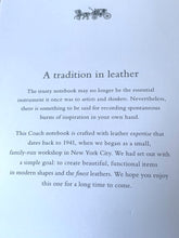 Load image into Gallery viewer, A white paper card with printed text reading 'A tradition in leather' and a small horse-drawn carriage illustration at the top, likely part of a notebook or booklet insert.
